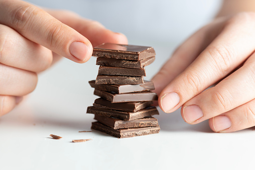 A woman stacking chocolate chips.