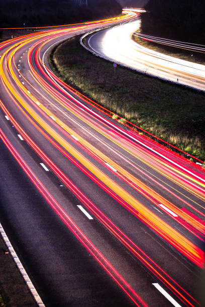 Night shot of a highway with light trails of cars