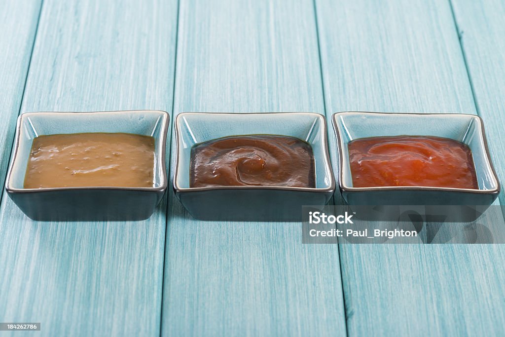 Asian Style Dips Hoisin sauce, soybean paste and chili sauce on a blue background. Asia Stock Photo