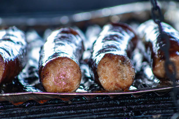 istock Sizzling sausage on a campfire grill during a fun barbecue. 1842638920