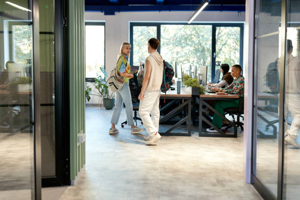 istock People arriving in the modern office 1842642583
