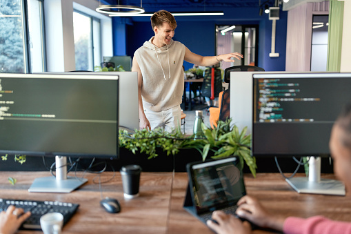 Beautiful, smiling man working in the IT company