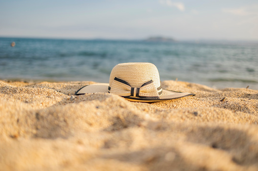 Fashionable straw hat on the beach.