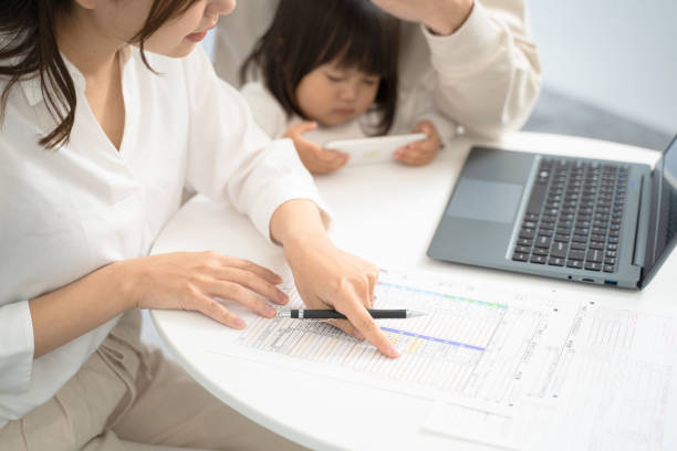 istock At hand preparing tax return documents. The contents written in this document are official Japanese documents and there are no copyright issues. 1842662776