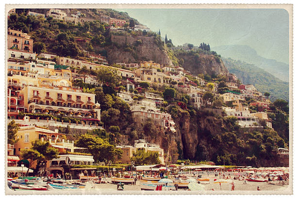 Positano Spiaggia Grande Beach - Vintage Postcard "Retro-styled postcard as seen from the Spiaggia Grande beach in Positano, Italy -- a famous tourist destination along the Amalfi Coast. All signage has been removed, all faces have been obscured and all artwork is my own. For hundreds of similar vintage postcards, click the banner below:" campania photos stock pictures, royalty-free photos & images