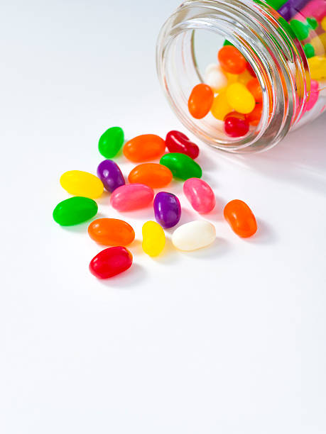 istock Jelly beans spill out of a jar 184266541