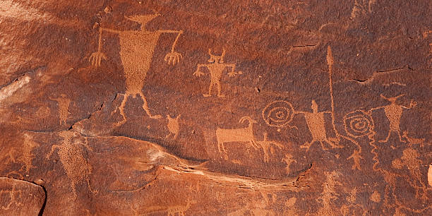 Petroglyphs on cliffs along Colorado River near Moab Utah USA "Petroglyphs on cliffs along Colorado River near Moab Utah, believed done by Indians of the Southern San Rafael Fremont culture between 600-1300 AD." archaelogy stock pictures, royalty-free photos & images
