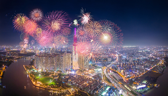 Celebration. Aerial view of Landmark 81 skyscraper with fireworks light up sky over business district in Ho Chi Minh City, Vietnam. Saigon bridge in night view. Holidays, celebrating New Year