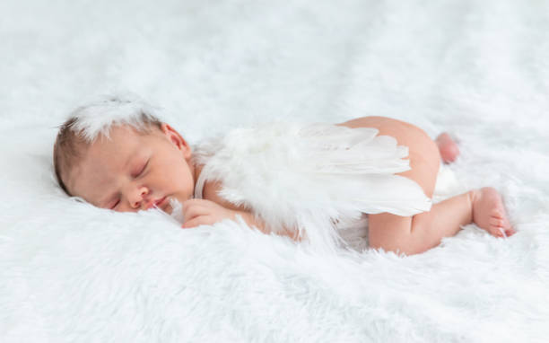 Newborn angel photo session in a suit. Selective focus.