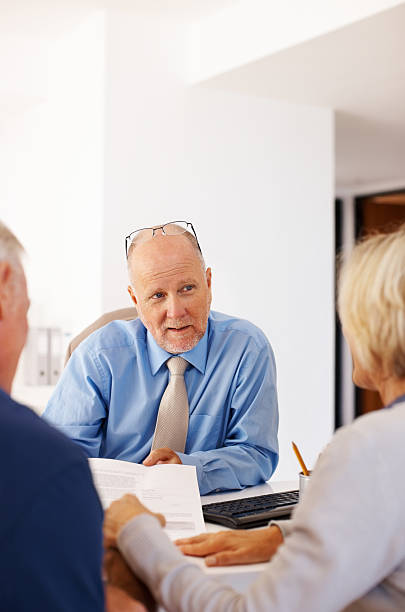 istock Financial advisor explaining investment plans to a couple 184267304