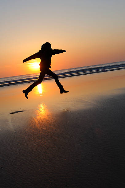 istock Woman Jumping At The Beach 184267350