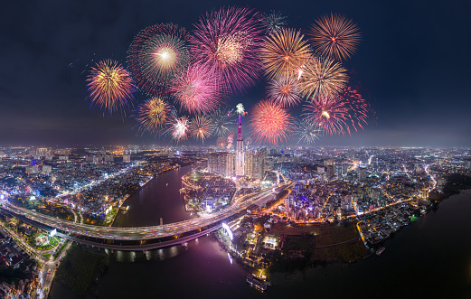 Celebration. Aerial view of Landmark 81 skyscraper with fireworks light up sky over business district in Ho Chi Minh City, Vietnam. Saigon bridge in night view. Holidays, celebrating New Year