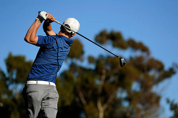 male golfers schwingende seine club - golfschwung stock-fotos und bilder