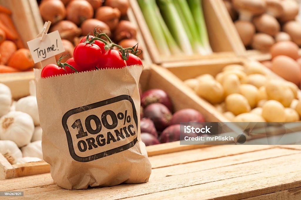 Fresh organic fruit and vegetables Try these fresh organic tomatoes! A collection of fruit and vegetables. Shallow depth of field, focus on the the bag of tomatoes in the foreground. Organic Stock Photo