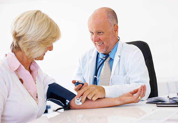 istock Senior lady getting her blood pressure checked by the doctor 184267917