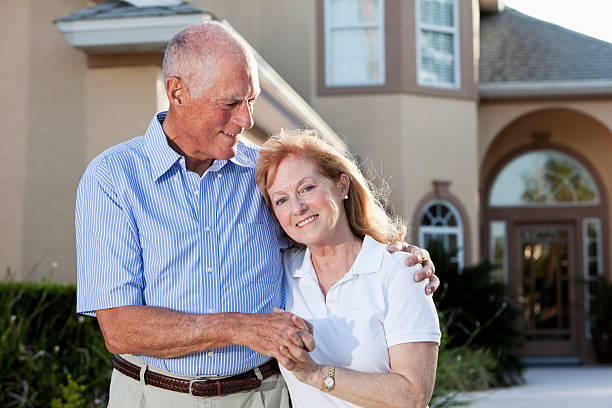 istock Senior couple in front of home. 184268310
