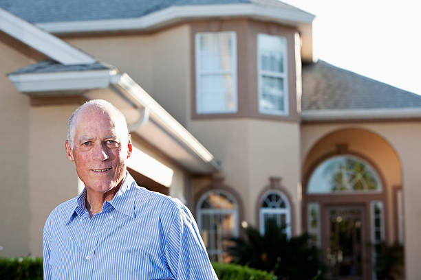 istock Senior man in front of home 184268313