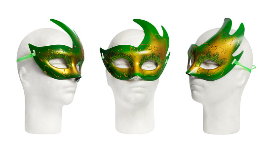 Green carnival or theatrical mask on mannequin head, 3 views, isolated. Clothing and accessories for Christmas or other holidays.