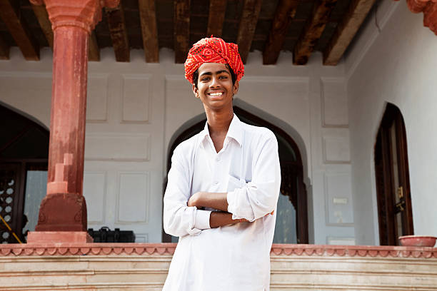 istock young indian man with red turban 184268760