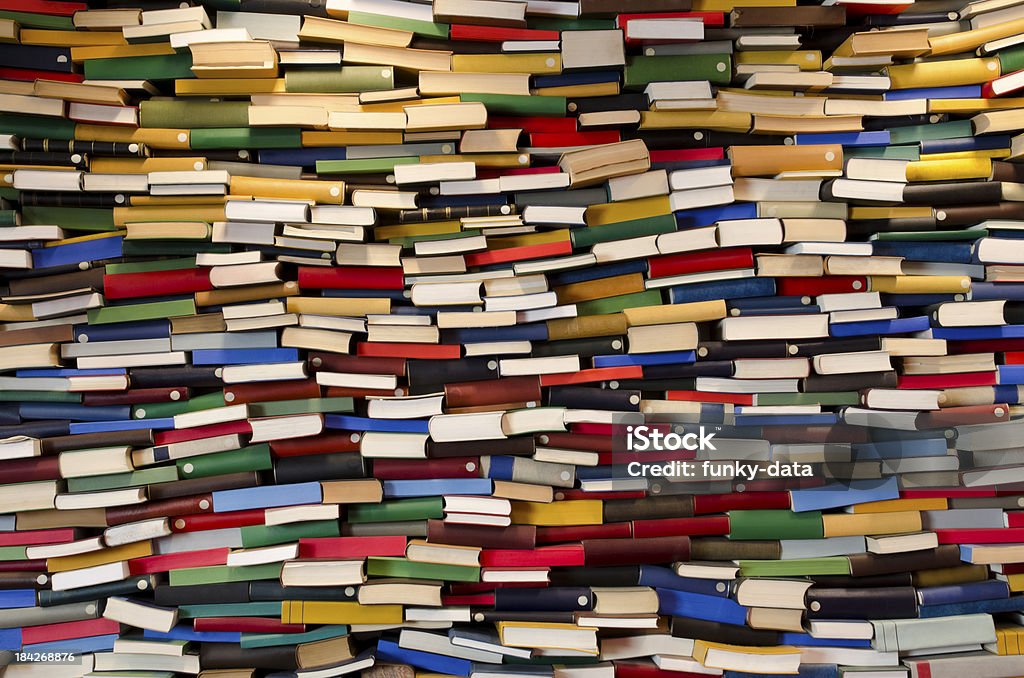 Huge stack of books - Book wall A lot of books stacked and forming a wall. Book Stock Photo