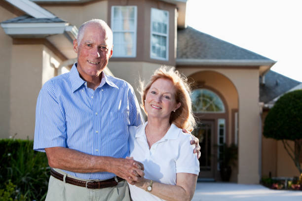 istock Senior couple in front of home. 184269600