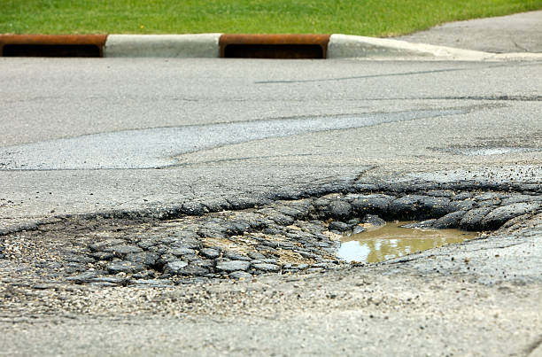 istock Large Road Pothole Ready to Swallow a Tire 184269694