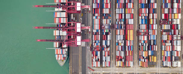 istock Industrial import-export port prepare to load containers. Aerial top view container ship in export and import global business and logistic. Global transportation and logistic business. 1842697050