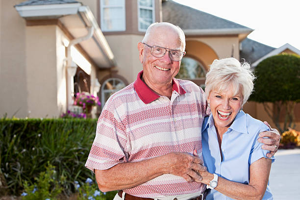 istock Senior couple in front of home. 184269775