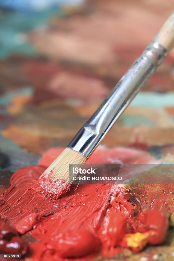 Paintbrush with red oil paint on a classical palette Paintbrush with red oil paint on a classical palette- OTHER artists materials related photos: Activity Stock Photo