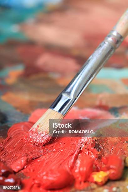 Paintbrush With Red Oil Paint On A Classical Palette Stock Photo - Download Image Now