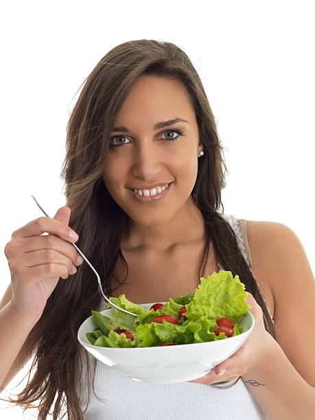 istock girl eating salad 184271030
