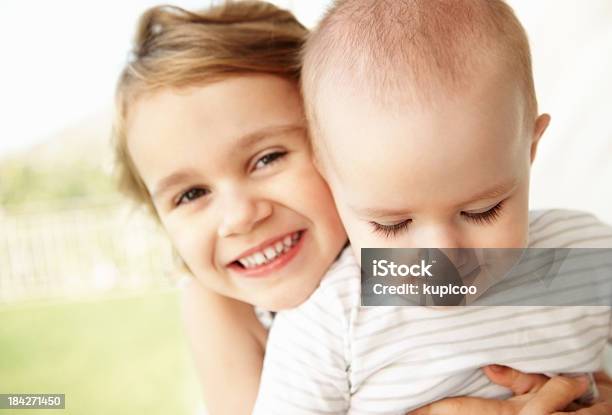 Foto de Sorrindo Jovem Garota Segurando O Bebê e mais fotos de stock de Abraçar - Abraçar, Bebê, Conceito