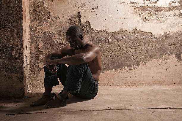 Prisoner in a dirty cell stock photo