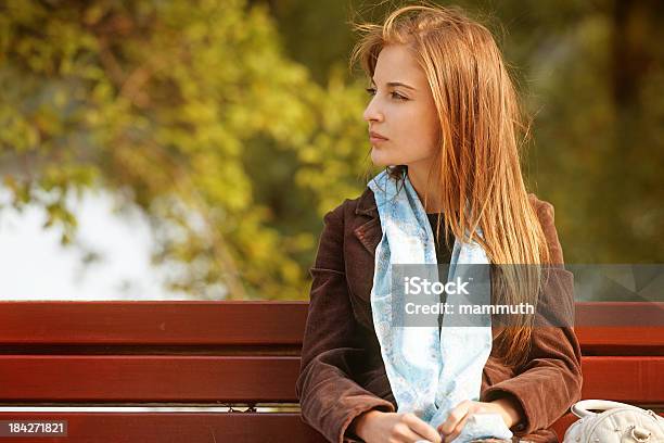 Girl Waiting In The Park Stock Photo - Download Image Now - One Woman Only, Outdoors, Sitting