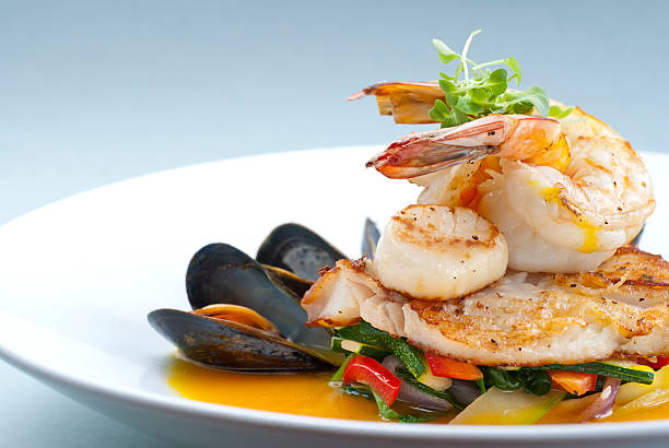 Healthy Seafood "Seafood medley of shrimp, scallops, mussels and fresh fish over a bed of vegetables." shrimp seafood photos stock pictures, royalty-free photos & images