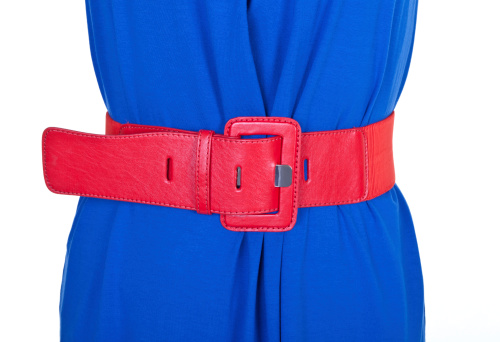 Woman's waistline - woman wearing a bright blue dress with a bright red leather belt to accentuate her waistline