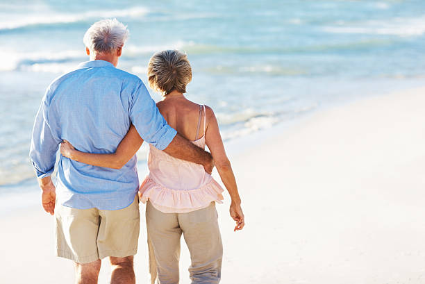 istock Senior couple taking a walk on the beach 184272154