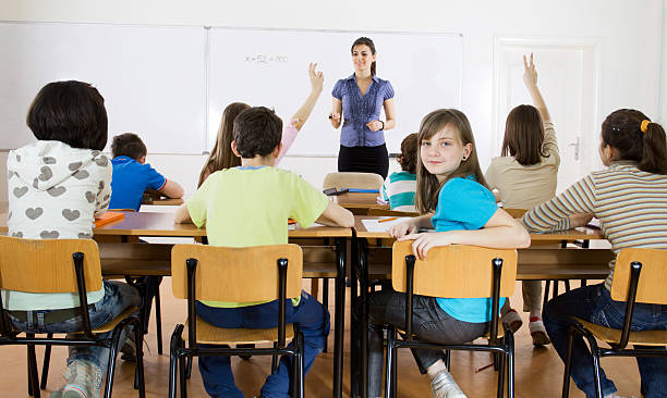 istock A group of children in a classroom with a teacher 184272411