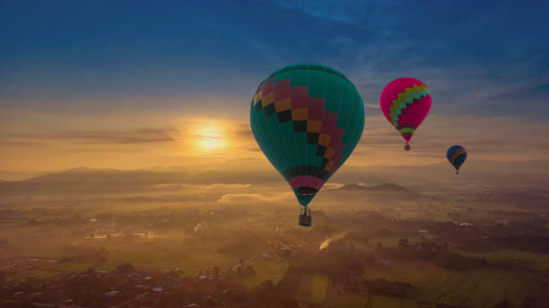 istock Three balloons in the sunset sky background. 1842727075