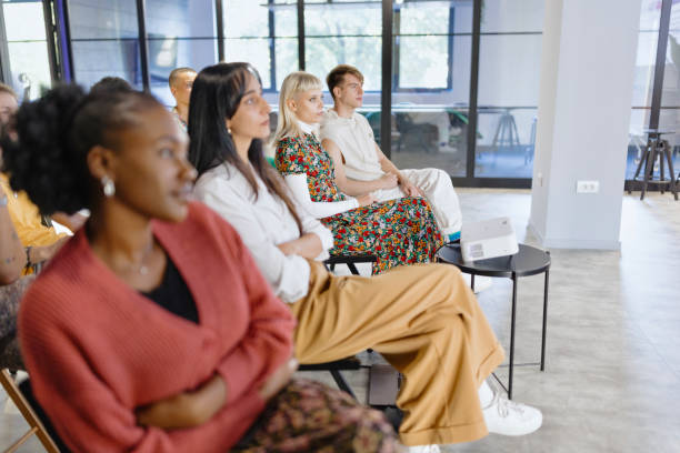 istock Diverse group of people attending a presentational speech in the modern office space 1842741403