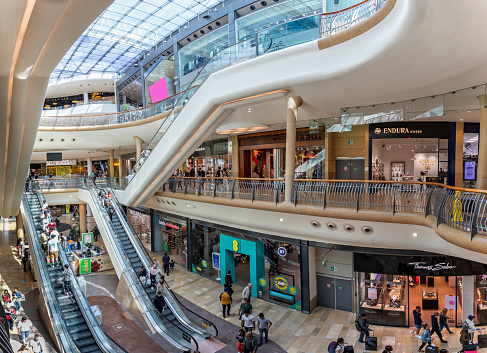 Busy scene with shoppers on escalators inside the Bullring Shopping Mall in Birmingham, West Midlands, UK on 23 July 2023