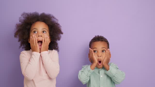 cute adorable African American children expressing surprice, shock
