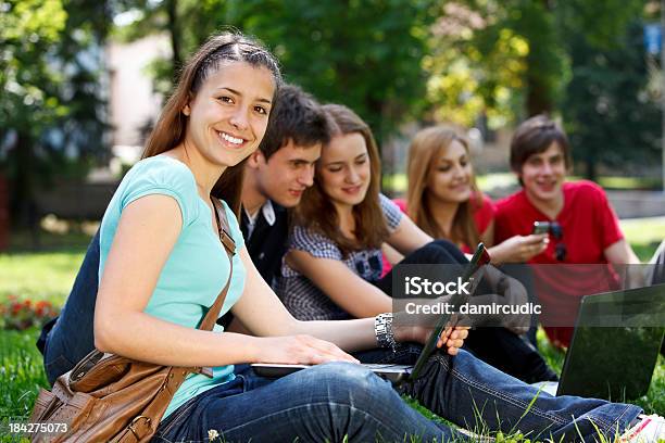 Group Of College Students Smiling And Studying On Campus Stock Photo - Download Image Now