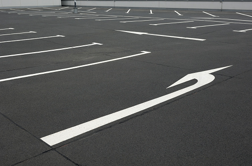 Arrows point the way on an empty parking lot.
