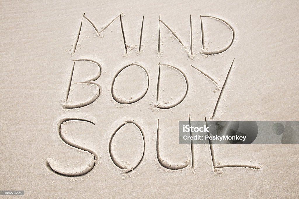 Mind Body Soul Inspiration Message Handwritten in Sand Simple message in sand spells out Mind Body and Soul Spirituality Stock Photo