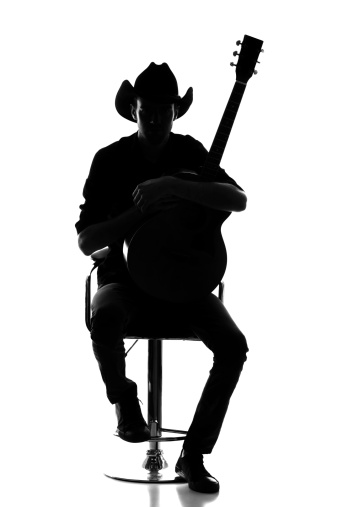 Cowboy silhouette with acoustic guitar