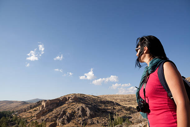 istock Young traveling woman with camera on journey 184275511