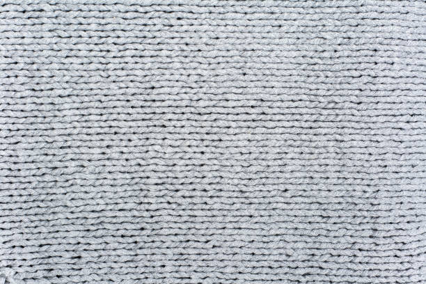 istock Sweater or scarf fabric texture large knitting. Knitted jersey background with a relief pattern. Wool hand- machine, handmade. 1842757527