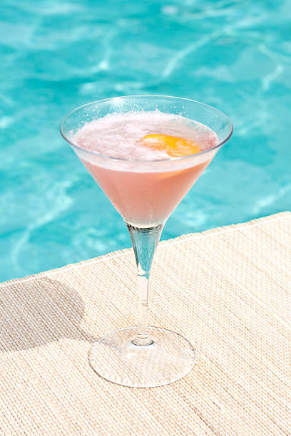 cosmopolitan cocktail near waterpool on the mat stock photo
