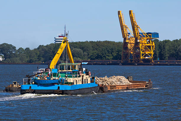 istock Tugboat towing a Barge with stones 184275971